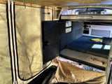 Spacious RV rental teardrop camper interior with bed & attached tent for camping comfort & outdoor living.