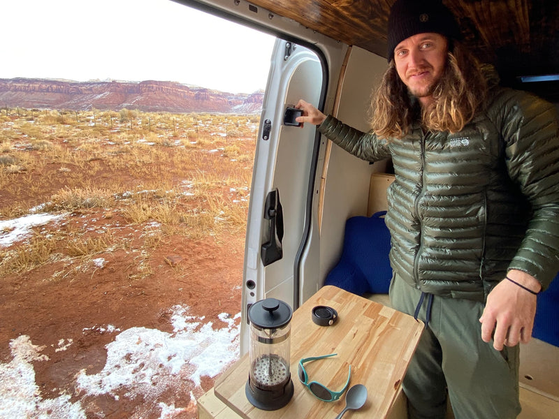  ideal for stargazing adventures.|This RV rental traveler enjoys an outdoor meal at a pull-out table in a white campervan — photo 3
