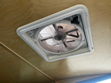 Efficient RV rental interior with a functional ceiling fan vent, providing comfortable airflow for your adventure.