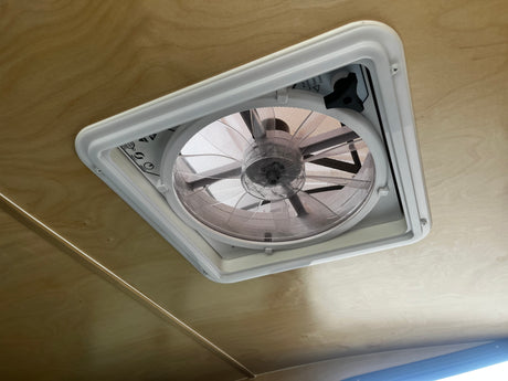 Efficient RV rental interior with a functional ceiling fan vent, providing comfortable airflow for your adventure.