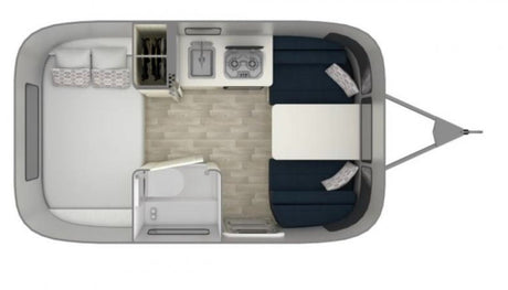 Overhead view of an RV rental camper floor plan, showing a bed, kitchen, dinette, and compact bath. Perfect for travel.