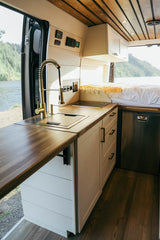 Experience comfort in this spacious RV rental! Features a fully equipped kitchenette, cozy bed, and scenic lake views.