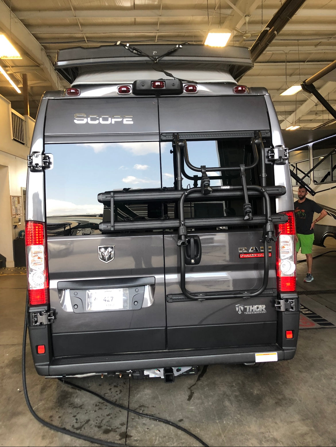 Gray Thor Scope Ram ProMaster Class B RV rental, rear view with bike rack & pop-top roof. Ideal for adventures!