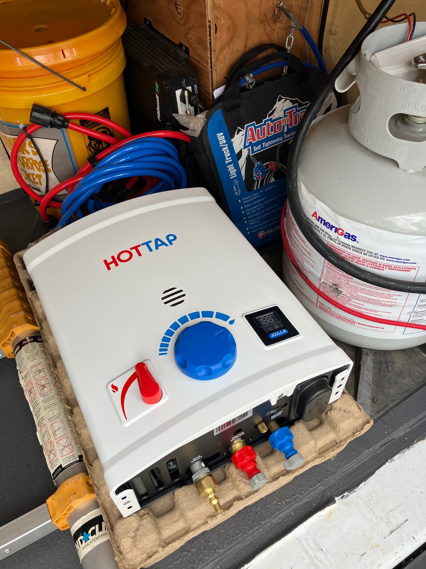 RV rental setup: Joolca HOTTAP portable water heater, AmeriGas propane tank, and power inverter for off-grid camping.