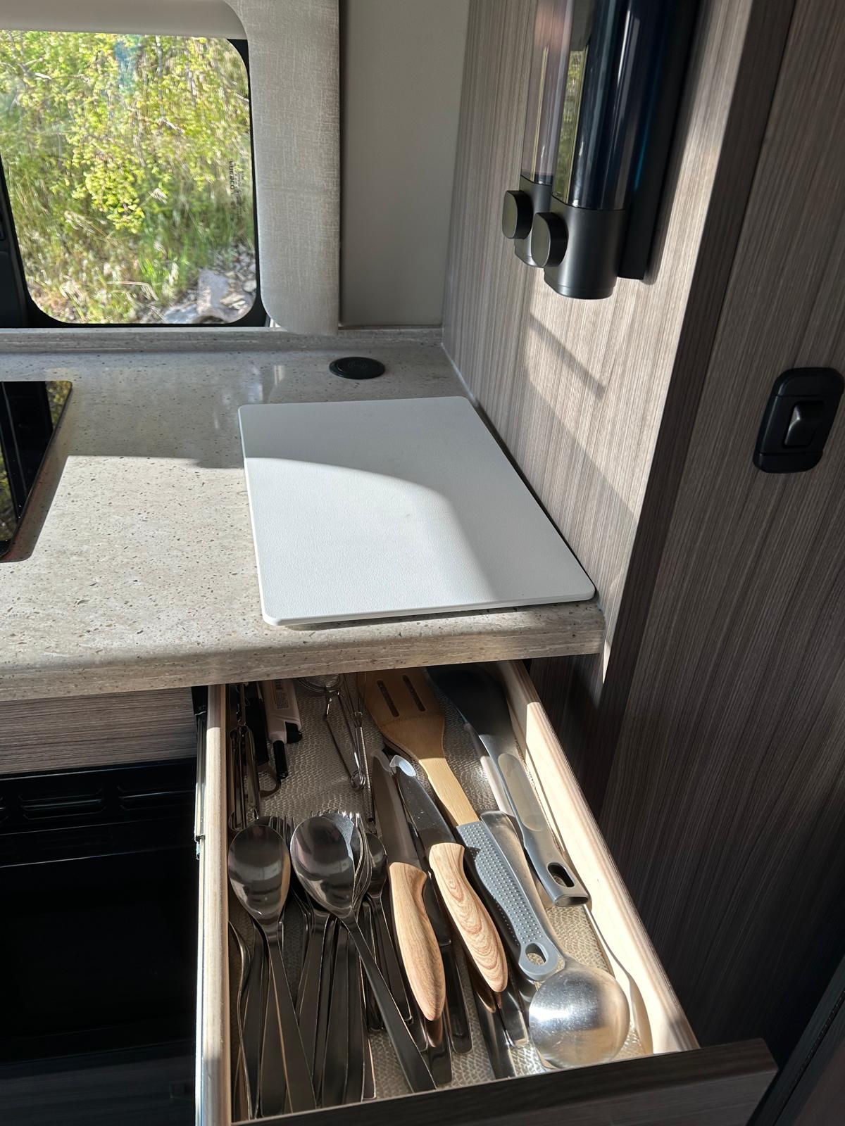  and a compact kitchenette.|Stylish RV rental kitchen featuring a speckled countertop — photo 7
