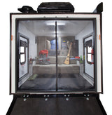 Inside an RV rental, this toy hauler offers a versatile living space with sofa-bed, screen door, and adventure gear.
