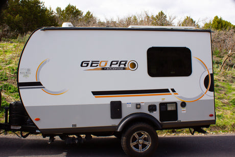 This compact white and grey GEO PRO travel trailer is ideal for an rv rental outdoor adventure.