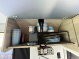 RV rental: Neatly organized overhead kitchen cabinet featuring a Minpresso coffee maker, dishes, and hanging storage.
