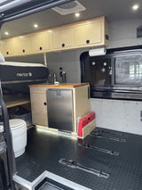 RV rental camper van interior featuring a Nectar bed, full kitchen with fridge, toilet, and ample storage for your journey.