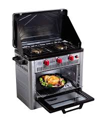 Compact RV rental camping kitchen: portable gas stove & oven with chicken inside. Ideal for trips.