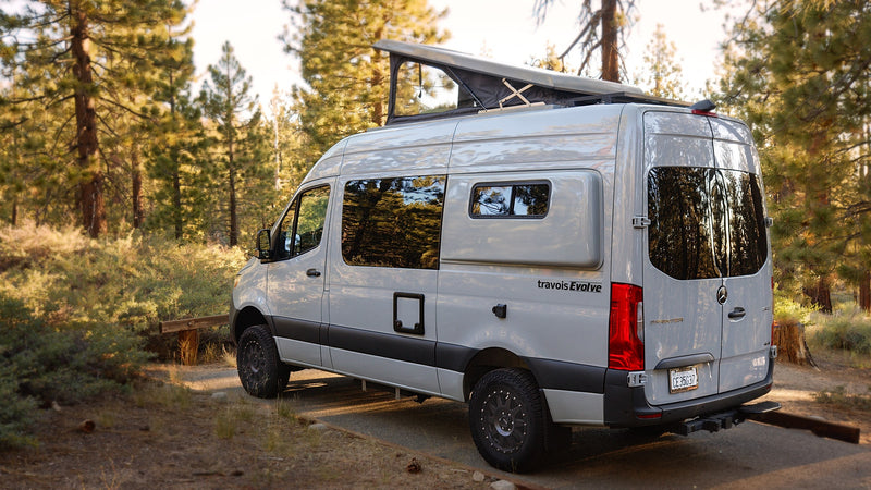Explore nature with this pop-top Mercedes Sprinter rv rental camper van, parked in a sunlit forest, perfect for your next camping adventure. — photo 4