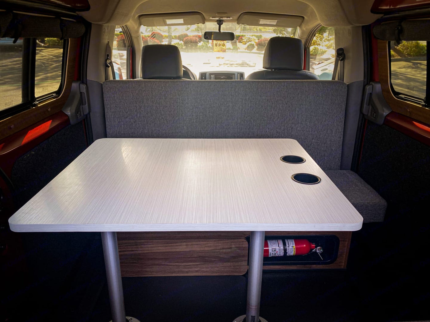 Cozy RV rental interior: A dining table, bench seat, and fire extinguisher are ready for your safe road trip adventure. — photo 3