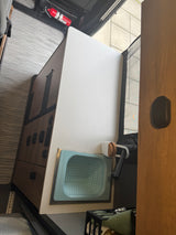 Inside an rv rental: compact kitchen with collapsible sink, fire extinguisher, and smart storage solutions.