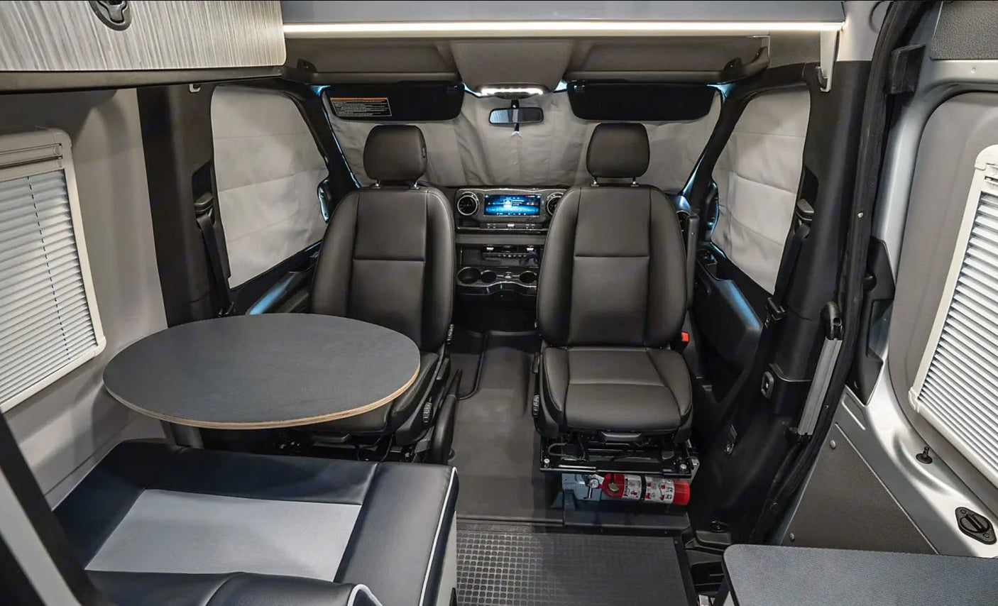 This RV rental's versatile interior features front seats that swivel, a removable table, and comfortable bench seating, ideal for road trips.