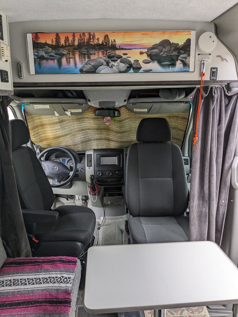  overlooks a foggy ocean.|Rear view of a silver Sportsmobile Sprinter RV — photo 12