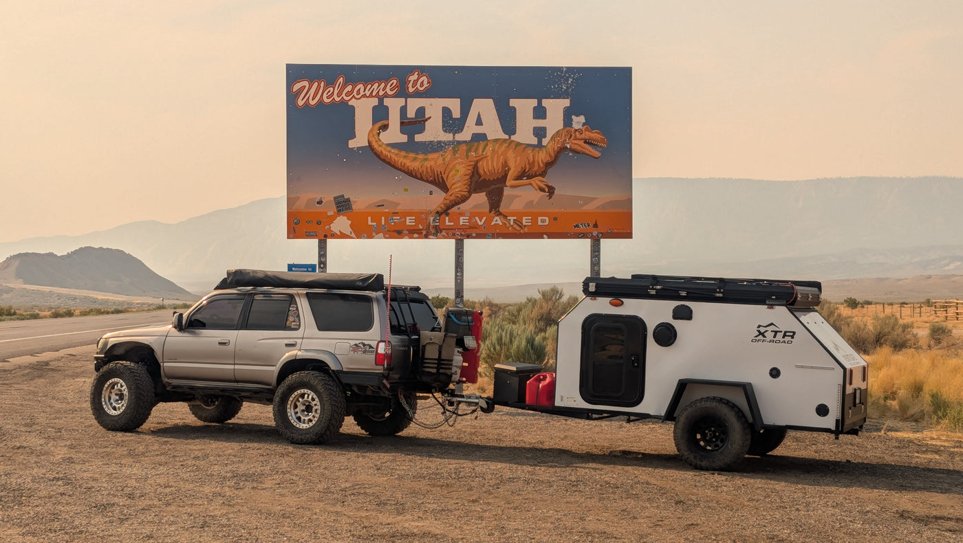 Adventure-ready SUV towing an RV rental camper at Utah's dinosaur welcome sign. — photo 18