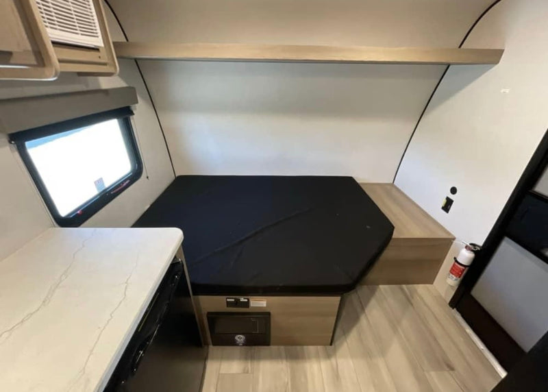 plus a cozy sleeping/seating area.|RV rental 13B floor plan: Compact travel trailer featuring shower — photo 3