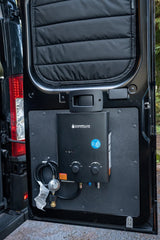 RV rental equipped with a Camplux portable water heater setup on the rear door, perfect for outdoor showers and hot water.