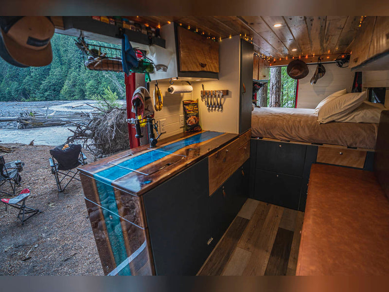  and distant mountains.|Cozy RV rental interior: wooden overhead cabinets — photo 6