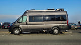 A sleek gray Ethos camper van, perfect for an RV rental, parked under a blue sky, ready for outdoor travel.