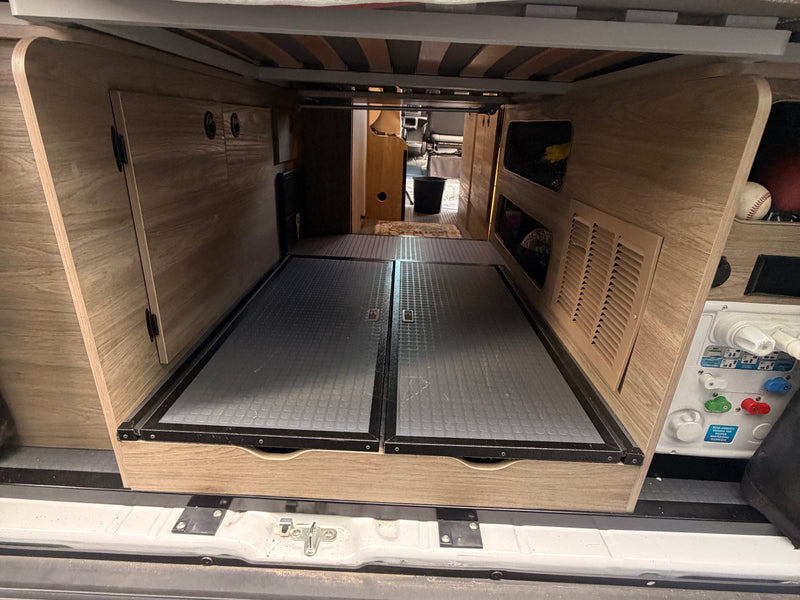  and detailed control panel.|RV rental interior: A compact kitchen with a two-burner stove (lid open — photo 13