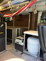  and surrounding trees.|Cozy RV rental interior with car seat