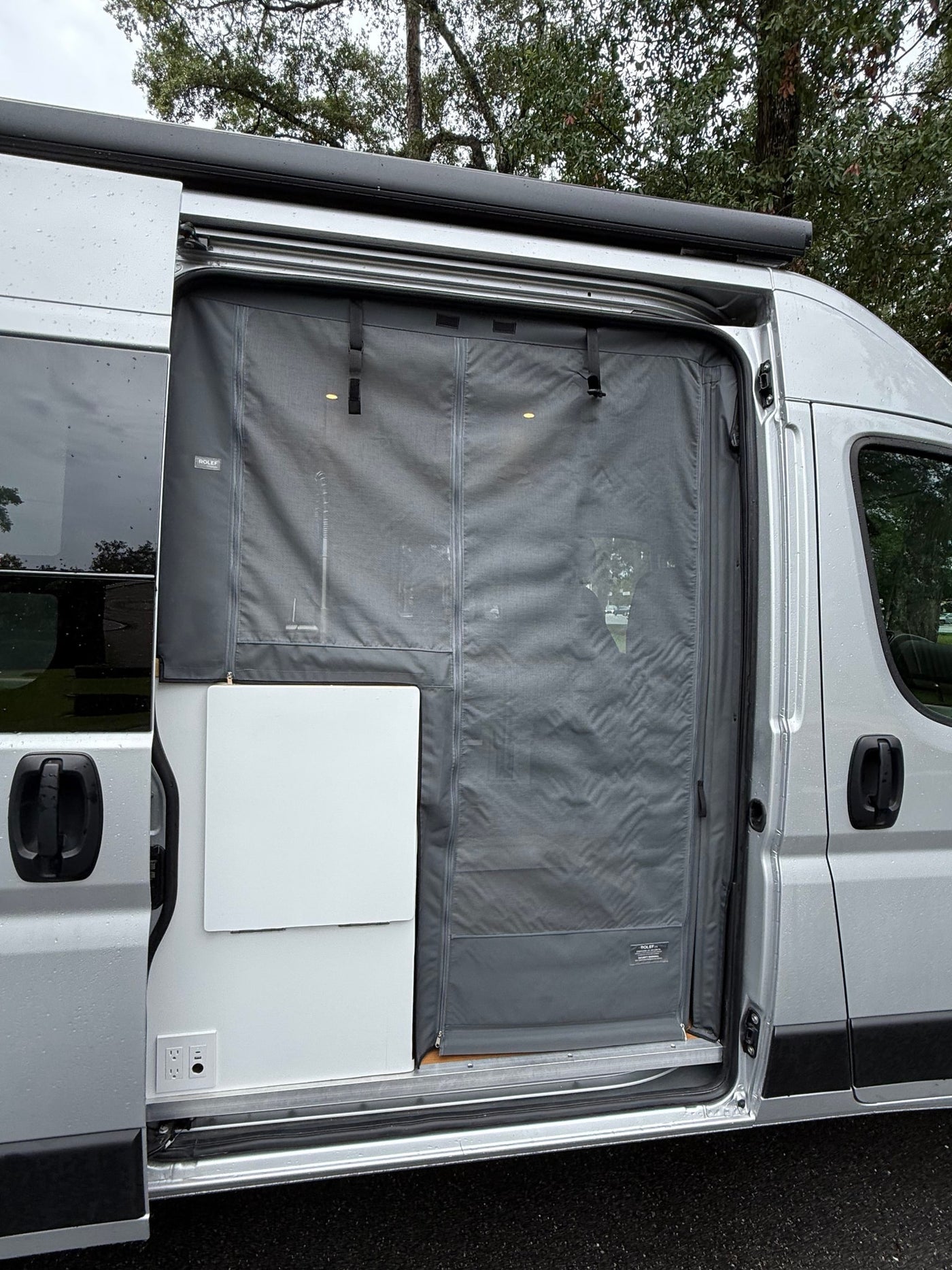  and stylish wood cabinetry.|RV rental interior: Pull-out wooden shelves with remotes and keys — photo 17