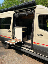 RV rental Storyteller camper van showcasing its convenient side table & interior. Ideal for road trips.