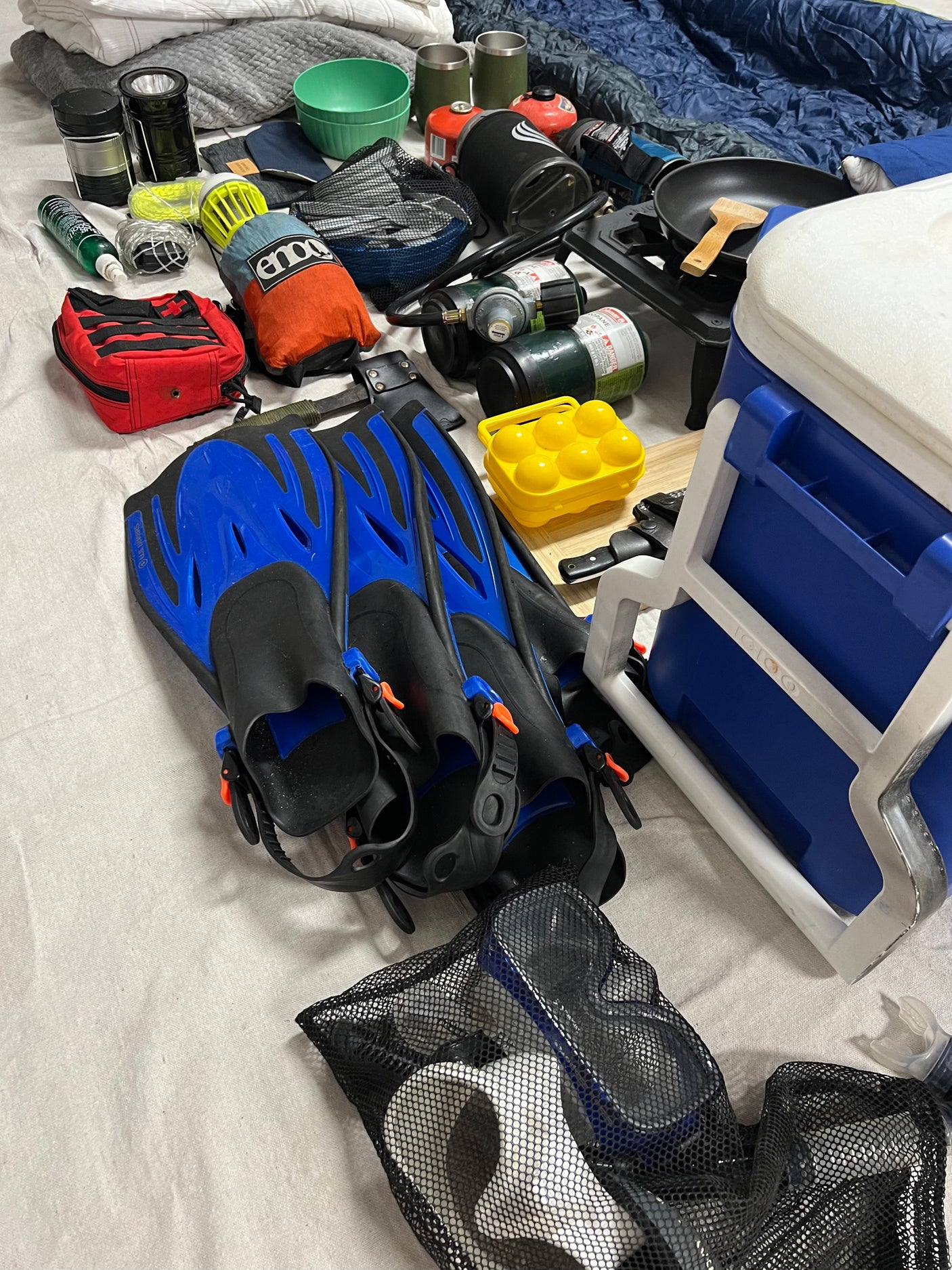 Packed for an RV rental trip: Snorkeling fins, camping stove, cooler, and other essential outdoor gear.