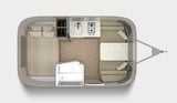 Floor plan of a compact RV rental, showing a rear bed, central kitchenette, front dinette, and small bathroom.