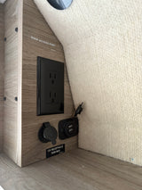 Inside an **RV rental**: a wood-grain panel with AC, 12V (180W max), and dual USB ports, and a "Roof Access Port" label.