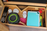 Neatly organized RV rental kitchen drawer. Includes knives, mugs, bowls, cutting boards, collapsible cookware, and spatulas.