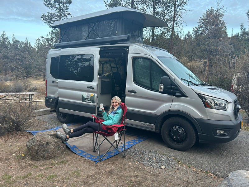 Woman relaxing by a ModVans pop-top rv rental van, perfect for camping and outdoor adventures. — photo 12
