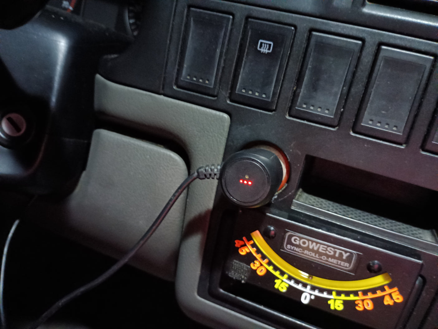 RV rental dashboard: A Gowesty roll-o-meter, 12V USB charger with red lights, and control switches are visible.
