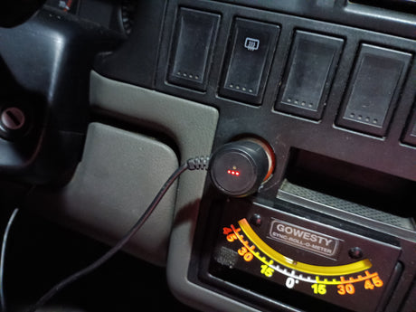 RV rental dashboard: A Gowesty roll-o-meter, 12V USB charger with red lights, and control switches are visible.