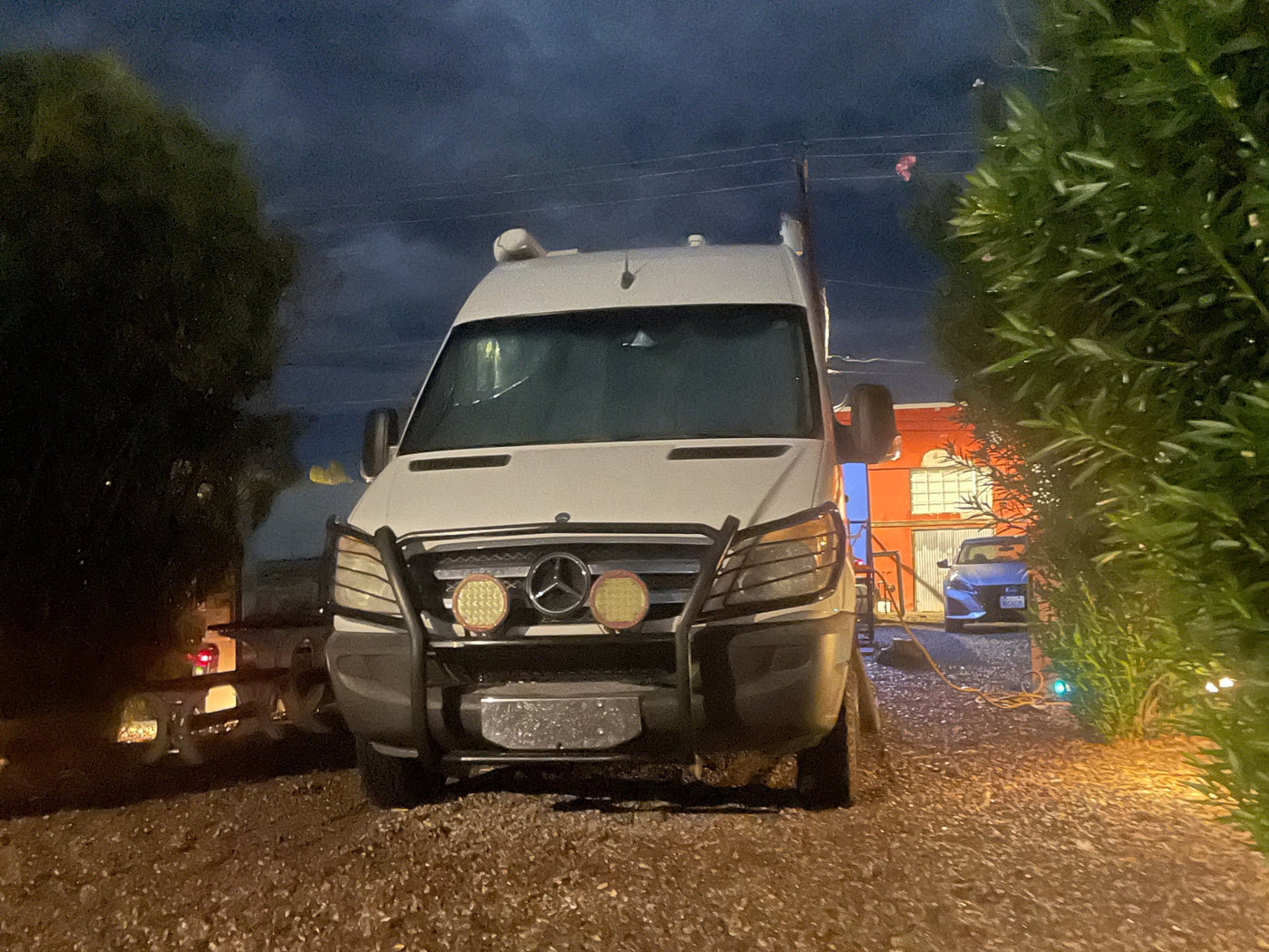  snowy ground.|White Pleasure-Way Sprinter rv rental at night — photo 5