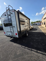 Explore Flagstaff E-Pro RV rental. This compact travel trailer is ready for adventure on a sunny day at the dealership.