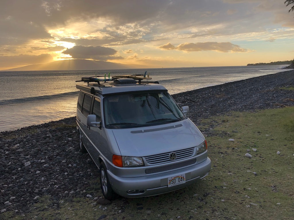 Experience coastal beauty! This silver VW camper van, loaded with surfboards, is an ideal rv rental for sunset beach adventures. — photo 17