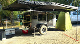 Explore the outdoors with this teardrop camper rv rental, featuring an outdoor kitchen, awning, and privacy tent.
