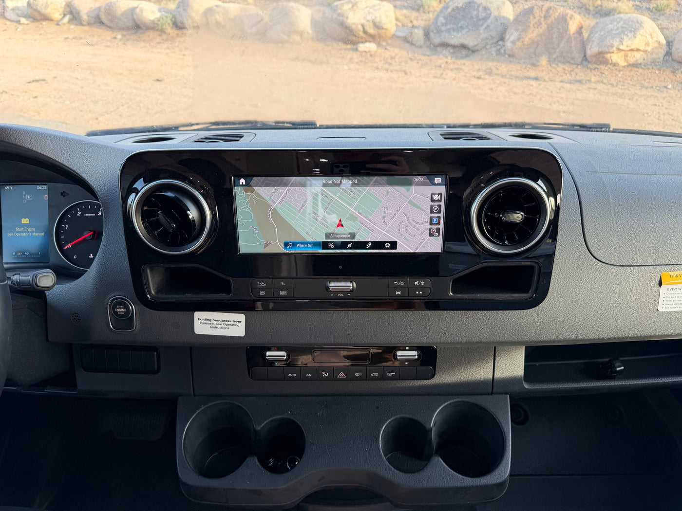 RV rental dashboard showing navigation in Albuquerque, climate controls, and instrument cluster details at 6:23 AM. — photo 14
