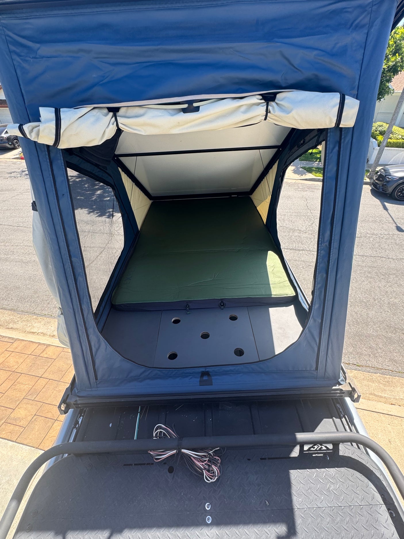 Spacious roof-top tent interior, ideal for your next RV rental adventure. Features a comfy mattress and airy design.