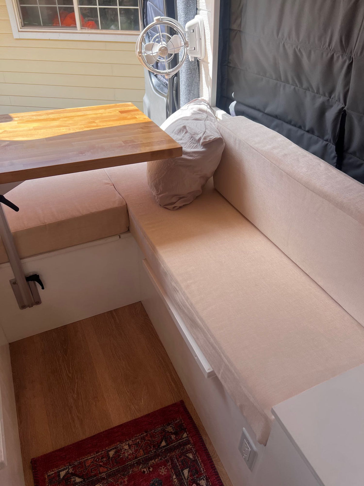  and stunning ocean views.|A dark Mercedes-Benz Sprinter rv rental camper van with open doors — photo 7