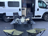 RV rental Winnebago Solis: Outdoor camping setup with Moon Lence chairs, table, & dinnerware. Ready for your next adventure!