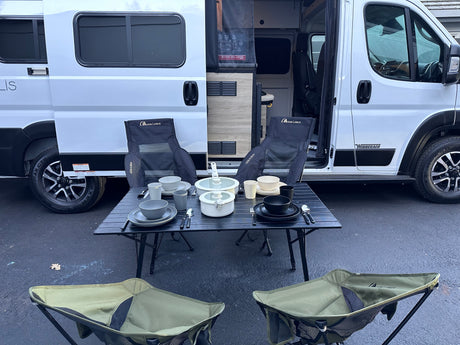RV rental Winnebago Solis: Outdoor camping setup with Moon Lence chairs, table, & dinnerware. Ready for your next adventure!