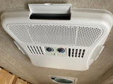 RV rental: Ceiling-mounted Dometic air conditioner unit showing fan speed and optional heat controls for comfort.