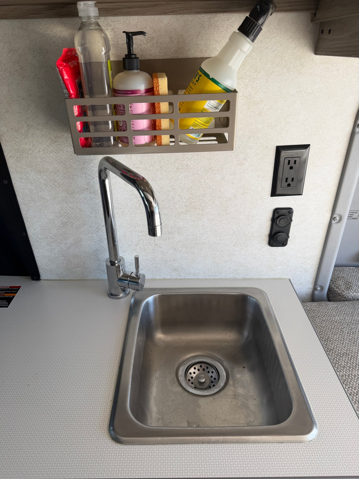  with palm trees outside.|RV rental interior featuring light passenger seats — photo 8
