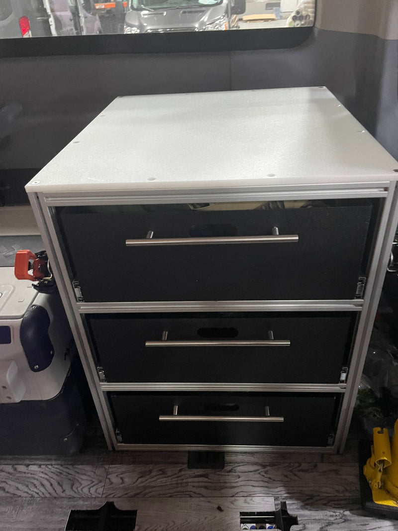 Compact custom drawer storage unit with three black drawers and silver handles, ideal for an RV rental interior. — photo 19