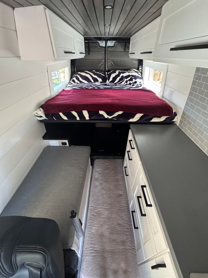  parked on a sunny driveway. Perfect rv rental adventure awaits!|A light gray Mercedes Sprinter **RV rental** sits parked — photo 15