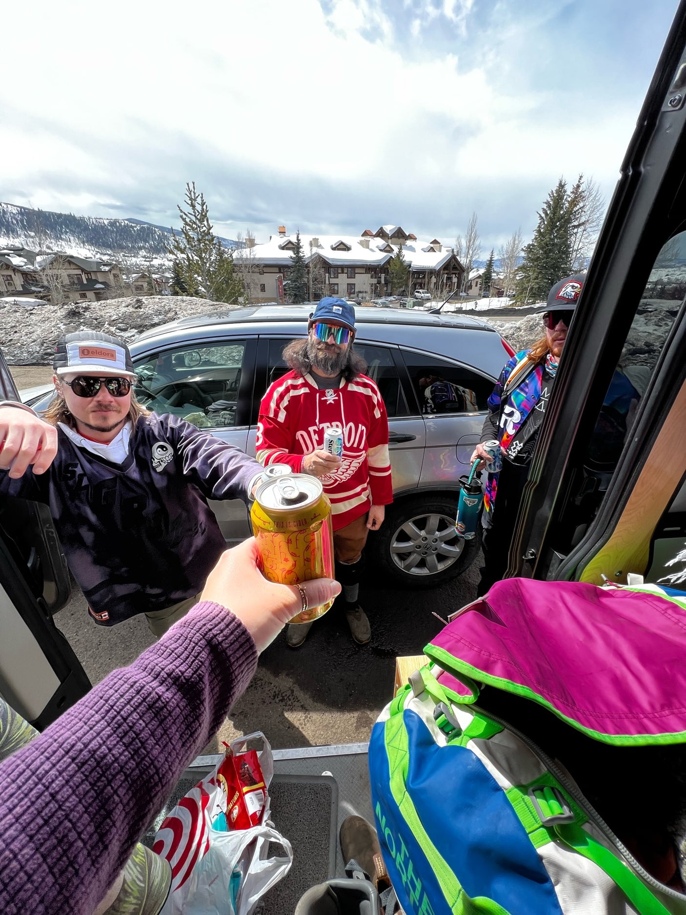 Ski trip crew with an RV rental, enjoying drinks in a snowy mountain village before hitting the slopes.