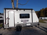 A sleek, new Sportsmen Classic travel trailer for RV rental, ideal for camping and outdoor adventures under a blue sky.